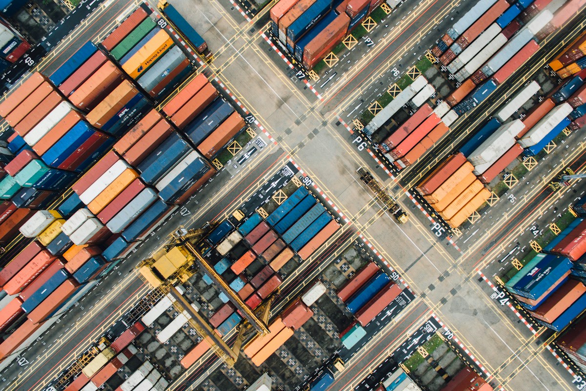 Shipping containers stacked at an industrial freight terminal